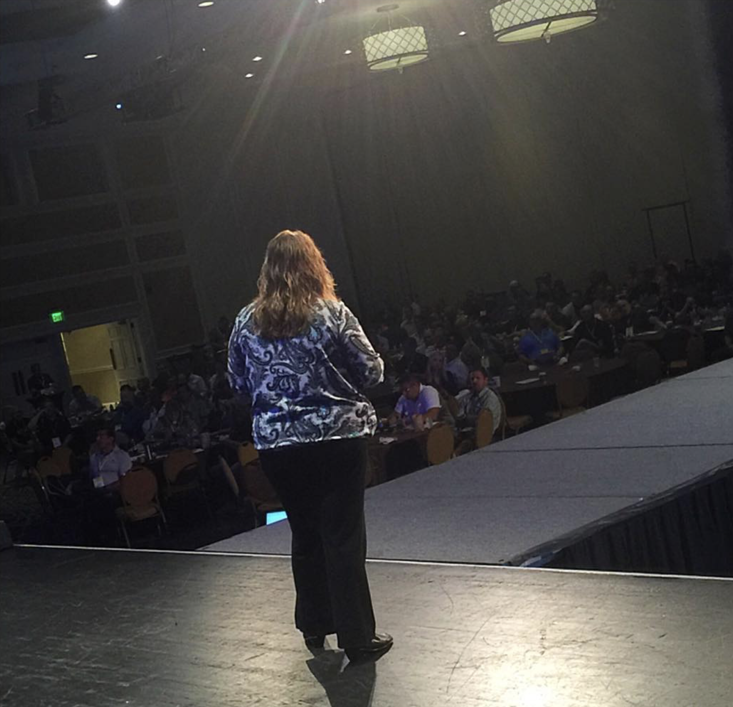 Angie Kiger speaking on stage